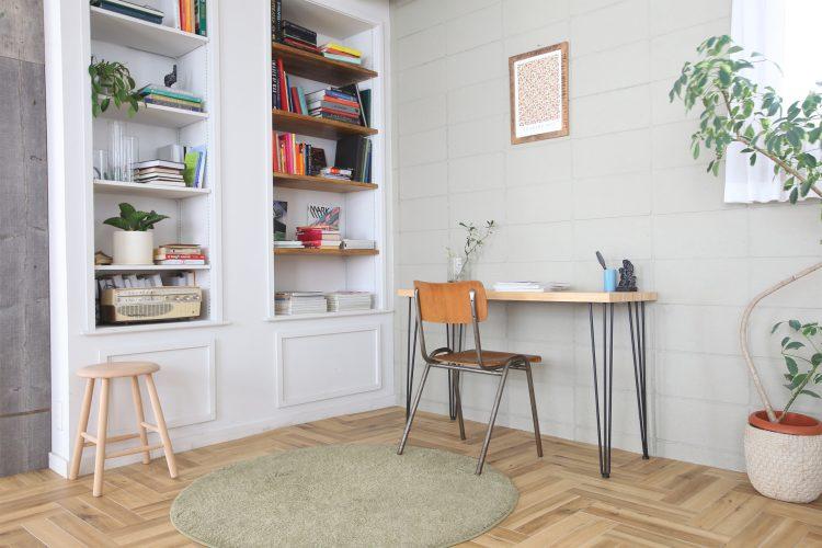 グレーのブロック壁とモールディングの本棚のコーナー