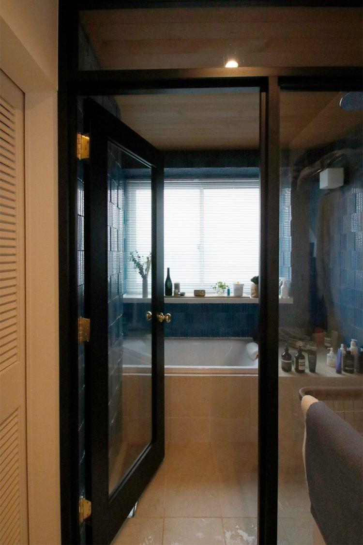 バスルーム入口はブラックフレームのガラス扉